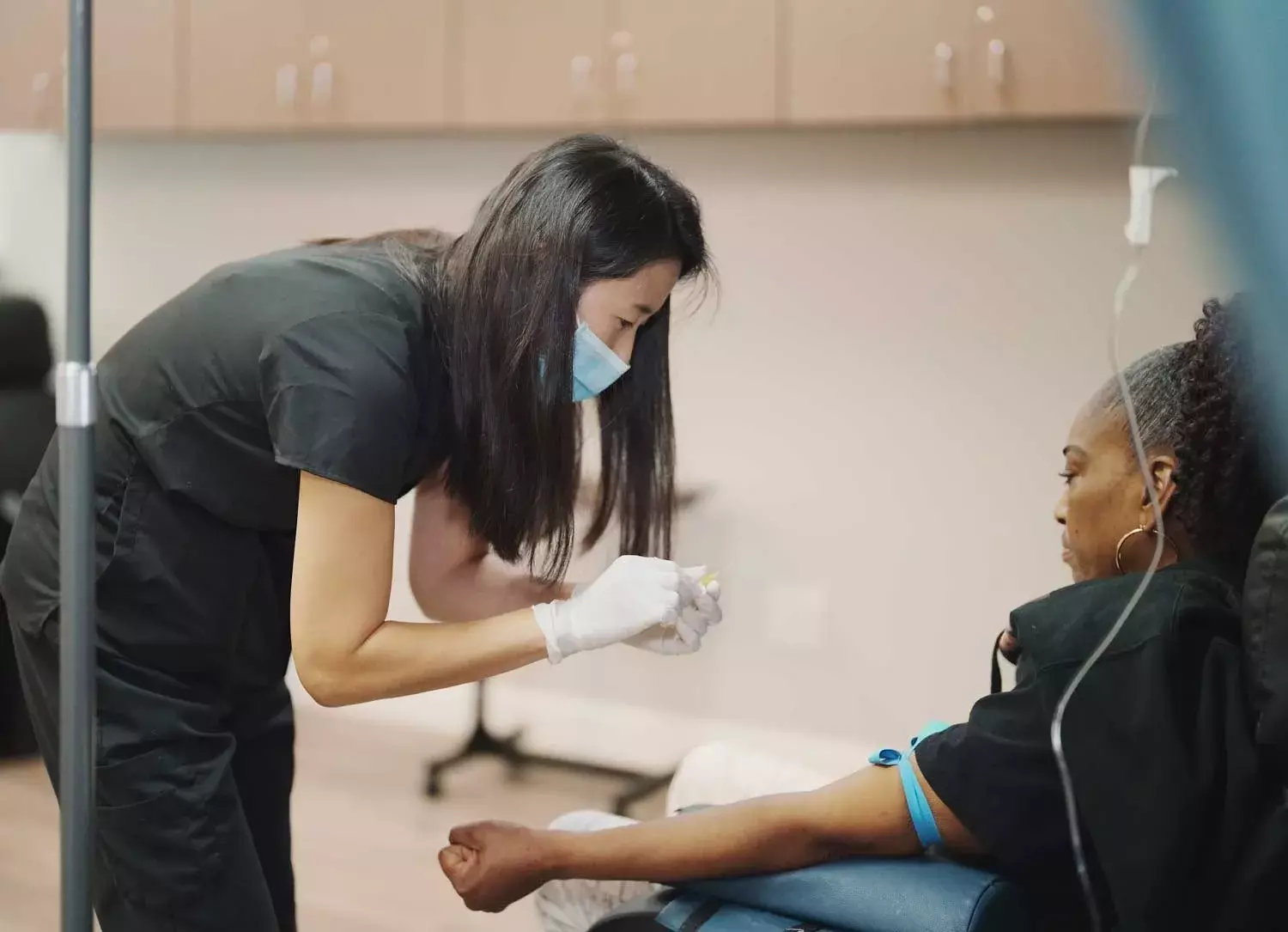 A nurse preparing an IV for a client at K Wellness